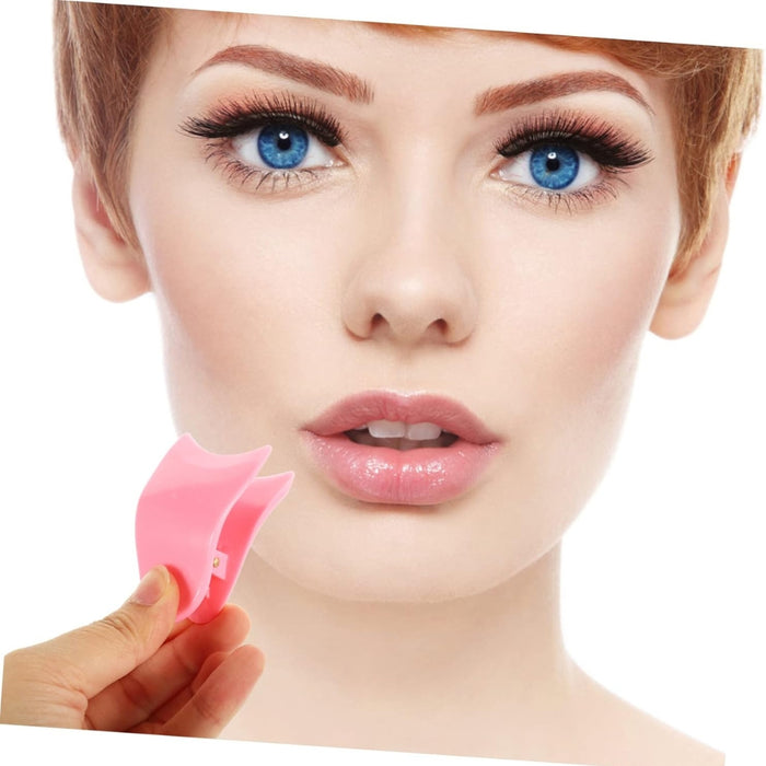Woman holding a pink lip brush with a white background