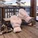  oversized fluffy pink mittens on rustic cabin porch with snow