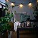 Outdoor evening setting with a cozy chair, lanterns, and candles on a table.
