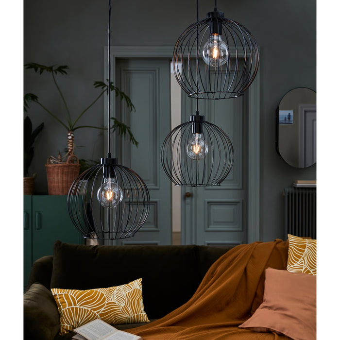 Modern living room with decorative pendant lights, a sofa, and a door in the background.