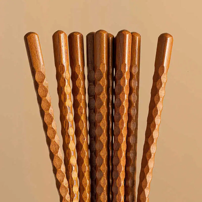 Set of wooden sticks with textured handles on a beige background
