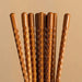Set of wooden sticks with textured handles on a beige background