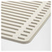 Beige bath mat with textured surface on a white background