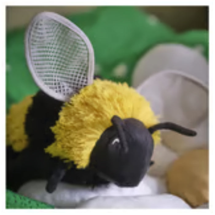 IKEA SKOGSDUVA soft toy – bumblebee plush on bed with green and white forest-themed bedding - 80576908