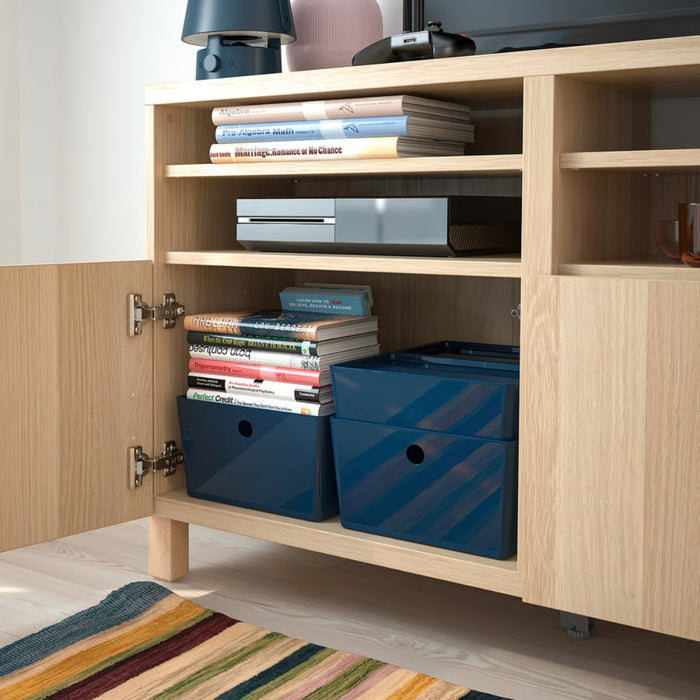 Open cabinet with KUGGIS boxes storing educational books like Algebra and Trigonometry, blending utility with neat aesthetics
