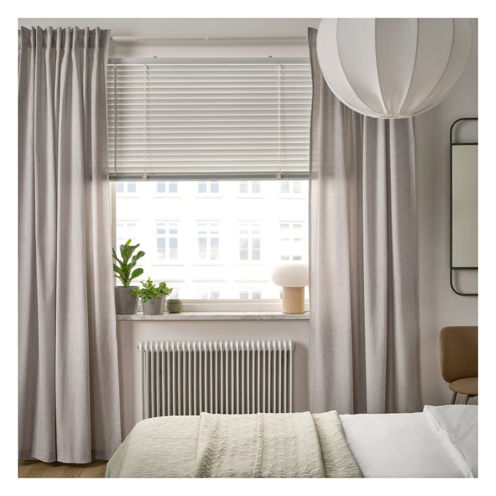 Living room with gray curtains, blinds, and a radiator.