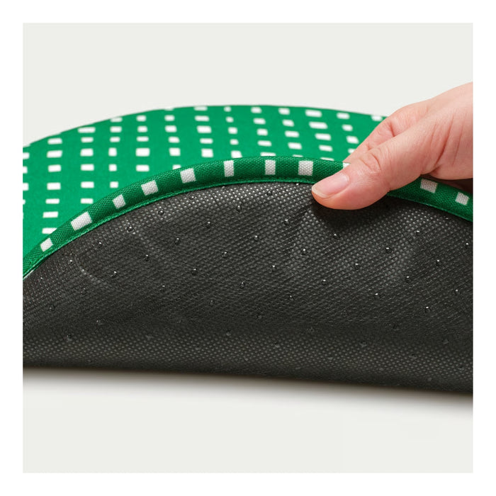 Hand holding a green and white patterned mat over a black textured surface