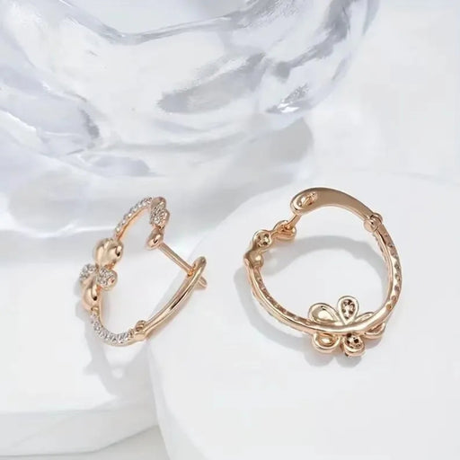 Pair of gold hoop earrings on a white fabric background