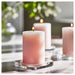IKEA LUGNARE Scented pillar candle, Jasmine/pink, 30 hr, trio of lit candles on glass holders with greenery backdrop – 90502139