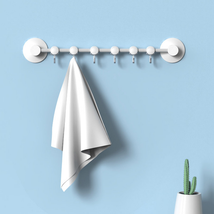 Six white plastic suction hooks in a movable row for hanging towels, keys and kitchen items