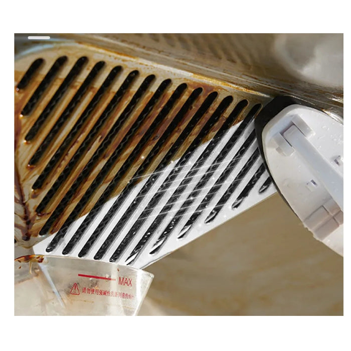 Cleaning a rusty metal drain with a white cleaning tool