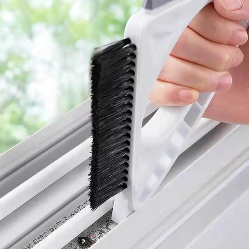 Person using a window cleaning brush to clean a window