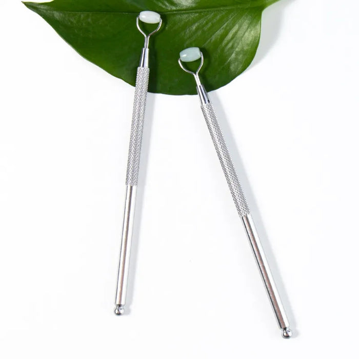 Jade Eye & Nose Massager – Dual-End Roller, Facial Circulation Tool, dual tools with jade rollers on green leaf background
