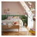 Bedroom with floral bedding, green walls, and a wooden floor.