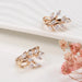 Rose gold wheat rings – matching leaf motif rings with zircon stones on ceramic tray