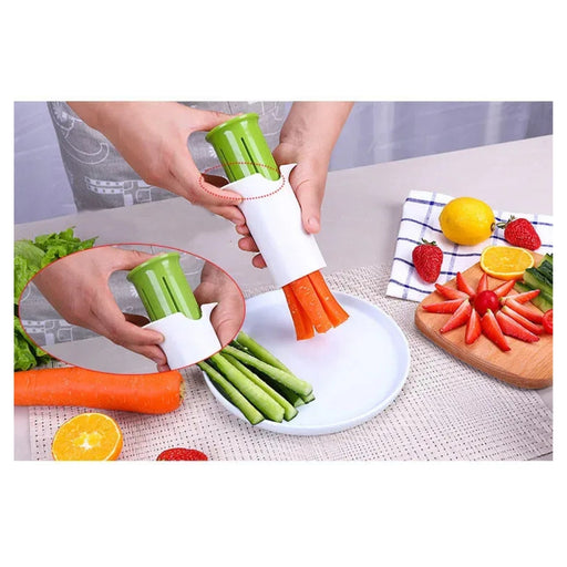 Vegetable peeler being used to peel carrots and celery on a table with fruits and vegetables.