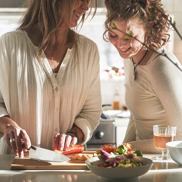 Two women preparing a meal together in a kitchen.