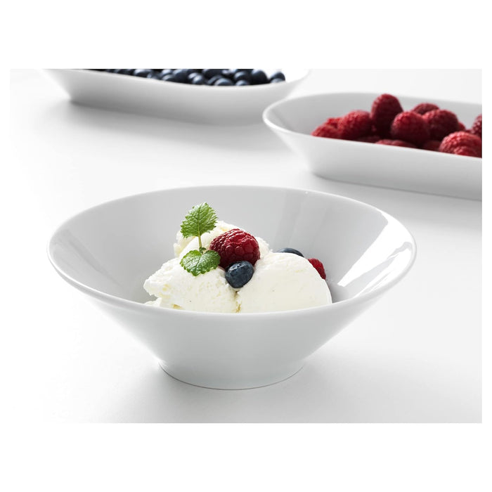 White bowl with dessert and berries on a white background