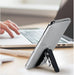 A compact, foldable tablet stand made of aluminum alloy with an adjustable multi-angle design and anti-slip base. Ideal for gaming, video streaming, reading, and working on tablets or smartphones."