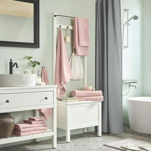 Bathroom with pink towels on a rack and white vanity