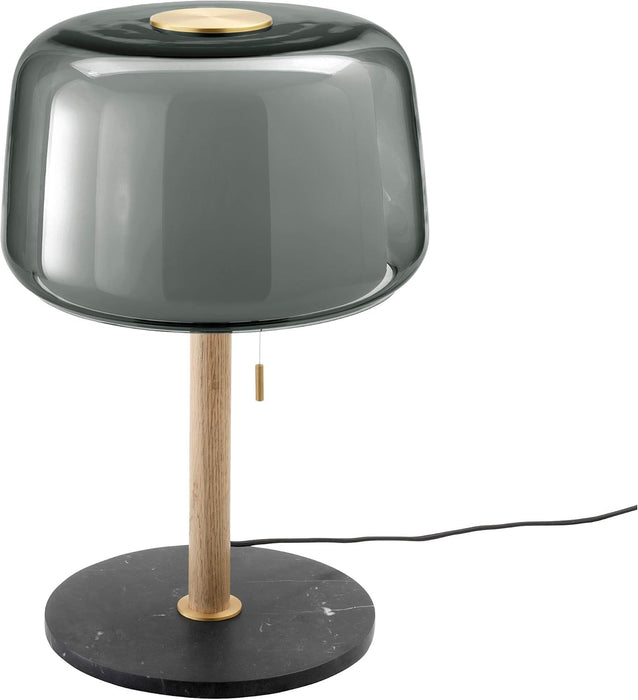 Table lamp with smoked glass shade, wooden base, and black marble base on a white background