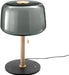Table lamp with smoked glass shade, wooden base, and black marble base on a white background