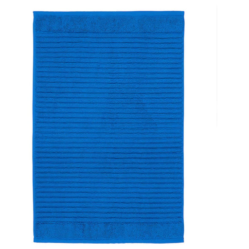 Blue bath mat with ribbed texture on a white background