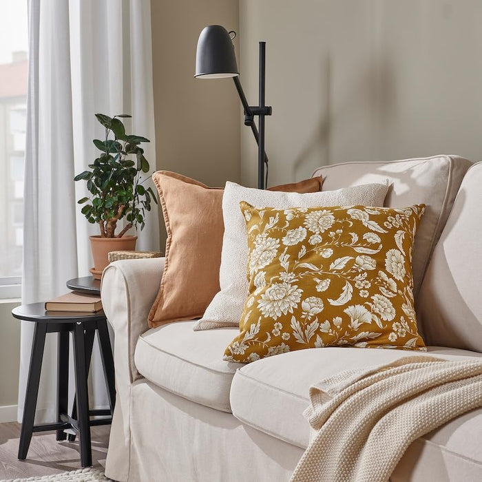 Living room setup with mustard floral cushion on beige sofa alongside rust and cream pillows – 20570990
