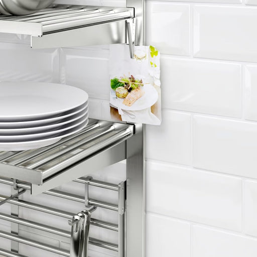  KUNGSFORS rail installed on tiled kitchen wall with stainless steel shelves, holding clipped recipe card and stacked plates