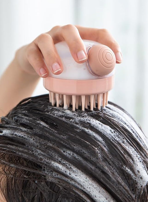 Hand using a scalp massager with flexible bristles on wet, soapy hair, distributing shampoo and gently massaging the scalp. Designed to improve blood circulation and enhance the effectiveness of hair cleansing- 159845334887912362179
