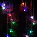 Solar-powered LED wind chime light featuring a delicate butterfly design, glowing in multiple colors against a night garden backdrop. Ideal for outdoor décor, providing a charming ambiance in yards, patios, and balconies.