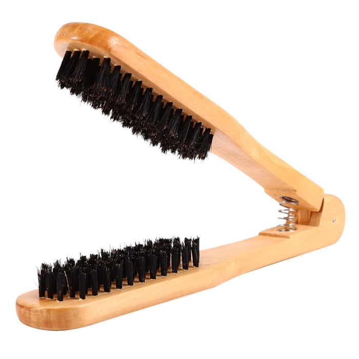 Wooden brush with black bristles on a white background