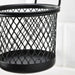 Black mesh basket on a white background