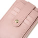 Close-up of a pink wallet with a gold button on a white background