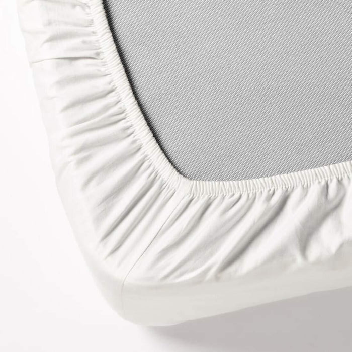 Detailed close-up of the smooth and breathable fabric texture of the white cotton-blend fitted sheet.