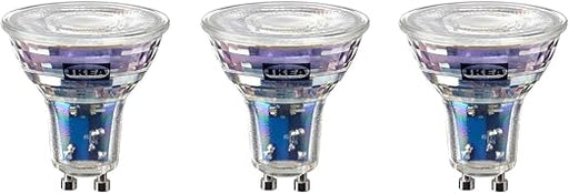 Three IKEA light bulbs with clear glass and metallic bases on a white background.