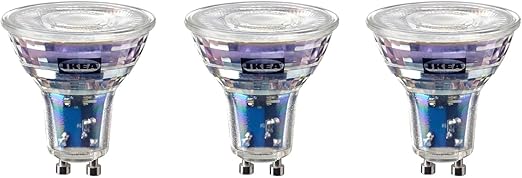 Three IKEA light bulbs with clear glass and metallic bases on a white background.