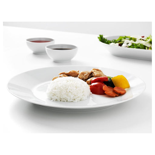 Plate of food with rice, vegetables, and meat on a white table.