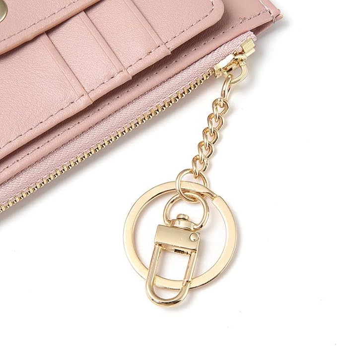 Pink wallet with a gold keychain on a white background