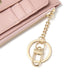 Pink wallet with a gold keychain on a white background