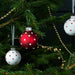 IKEA VINTERFINT Bauble: Close-up of a golden ornament with intricate patterns."