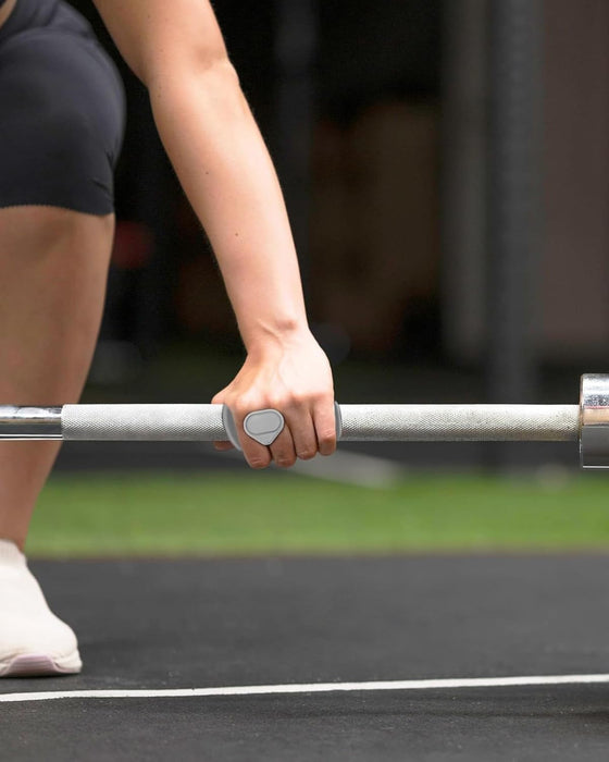 Person holding a barbell on a track