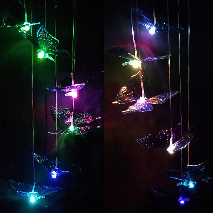 Solar-powered LED wind chime light featuring a delicate butterfly design, glowing in multiple colors against a night garden backdrop. Ideal for outdoor décor, providing a charming ambiance in yards, patios, and balconies.