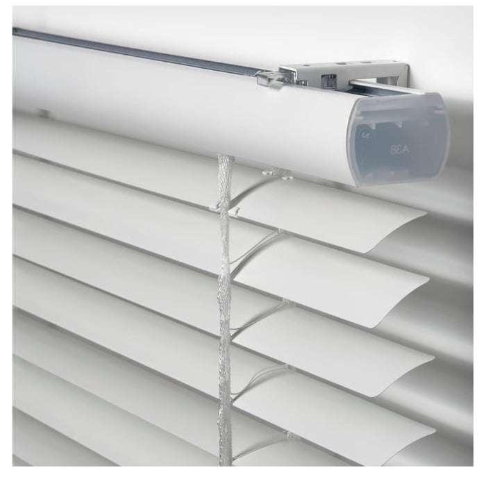 White venetian blinds with a roller on a white background
