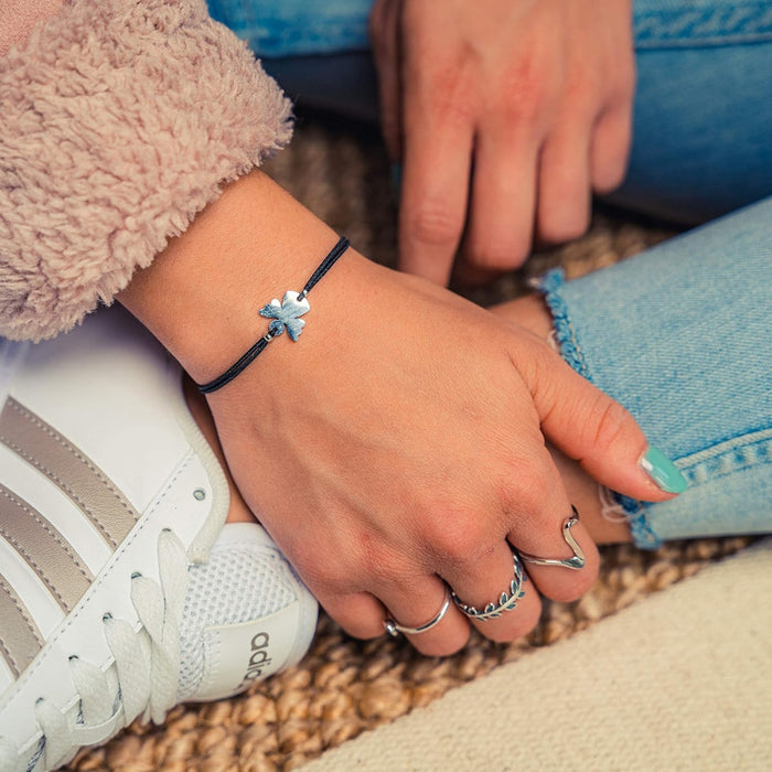 Couple Angel Bracelet – Adjustable Wax Cord, Stainless Steel Charm, shown with four-leaf clover charm and silver rings