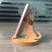 Digital Shoppy Wooden Phone Bracket, dog-shaped stand holding pink phone upright on circular base