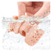 Close-up of a hand holding a pink silicone product with bubbles, on a white background