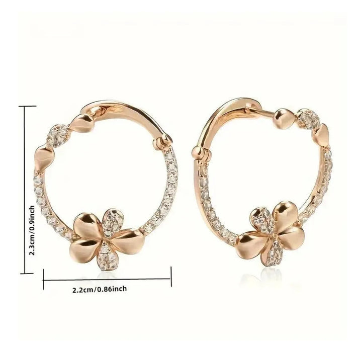 Rose gold hoop earrings with clover designs and measurements on a white background