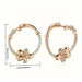 Rose gold hoop earrings with clover designs and measurements on a white background