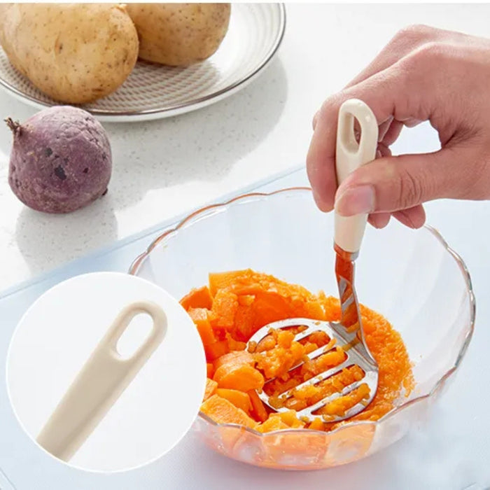 Stainless steel potato masher – ergonomic handle with inset view, used to mash sweet potatoes or carrots